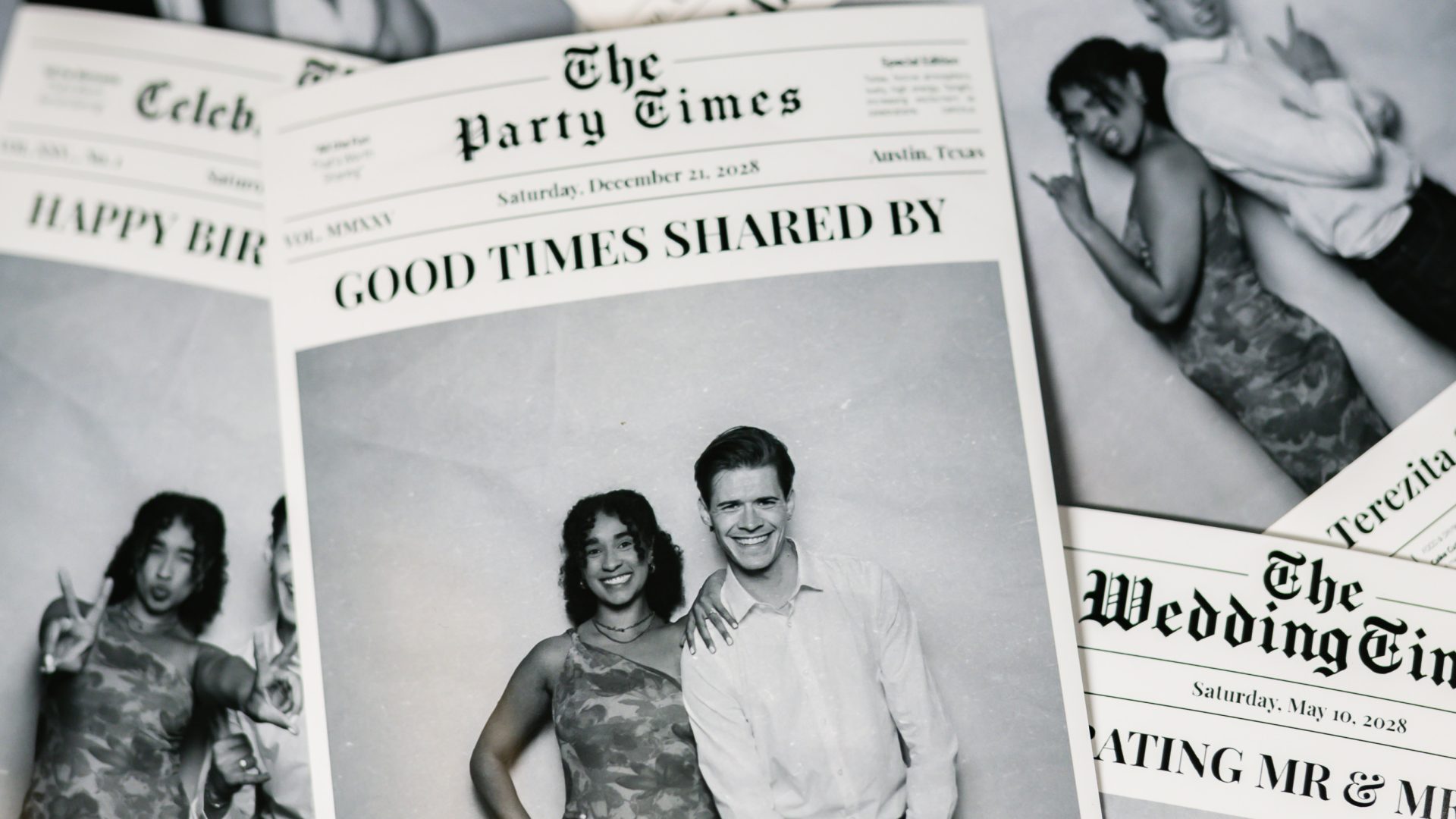 Stack of personalized newspaper-style party invitations featuring photos of a smiling couple.