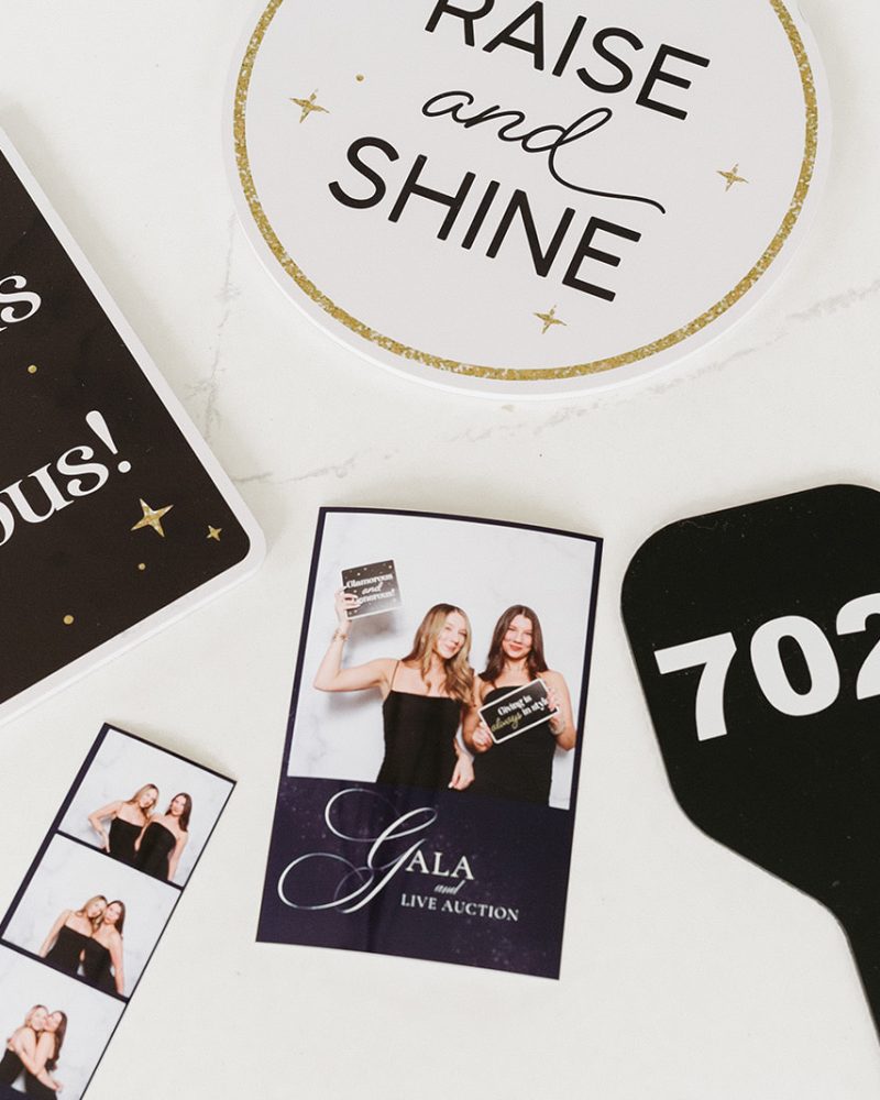 Gala event photo booth items: Glamorous and Generous sign, auction paddle, and pictures from the event.