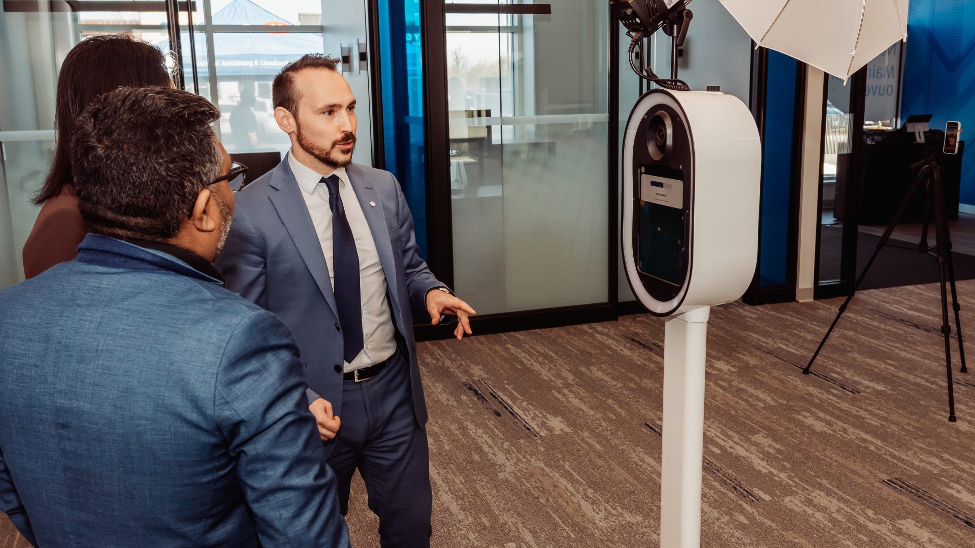 Business meeting discussing technology with professionals in a modern conference room setting.