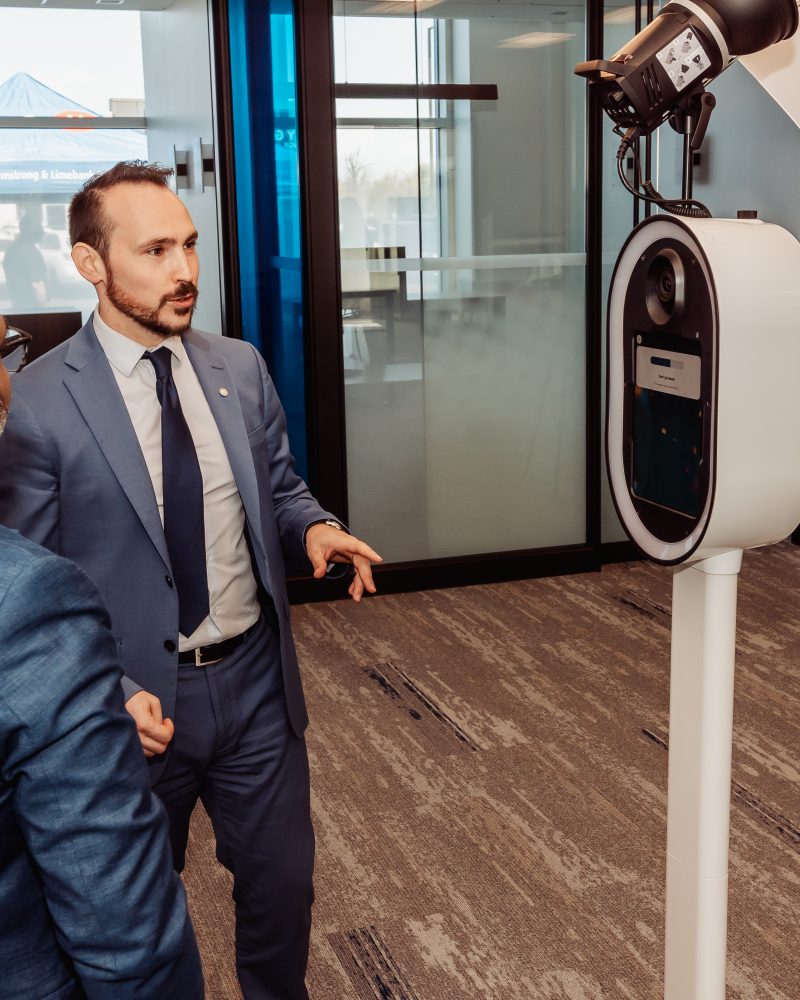 Business meeting discussing technology with professionals in a modern conference room setting.